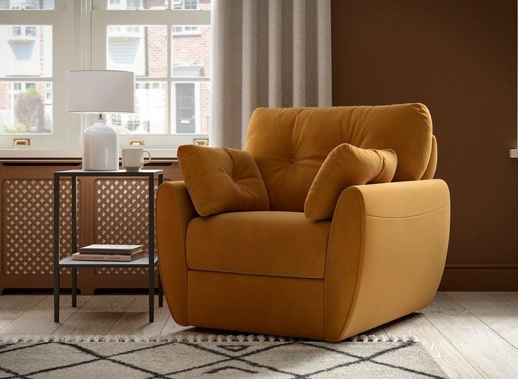 Mustard yellow armchair with plump cushions