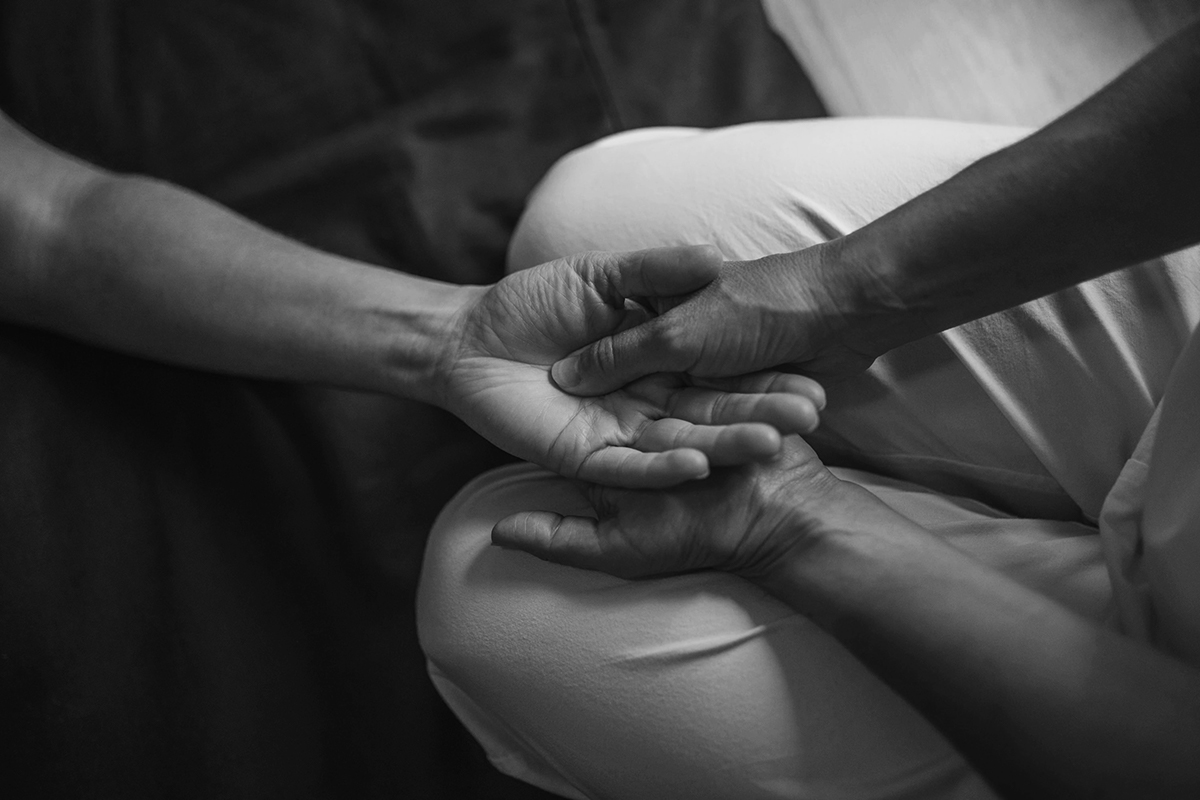 image of one person applying pressure to another person's pressure point on their wrist to help sleep