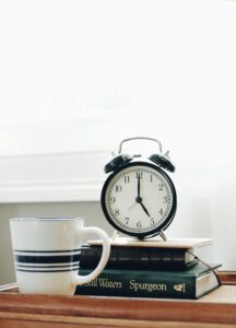 alarm clock on top of books