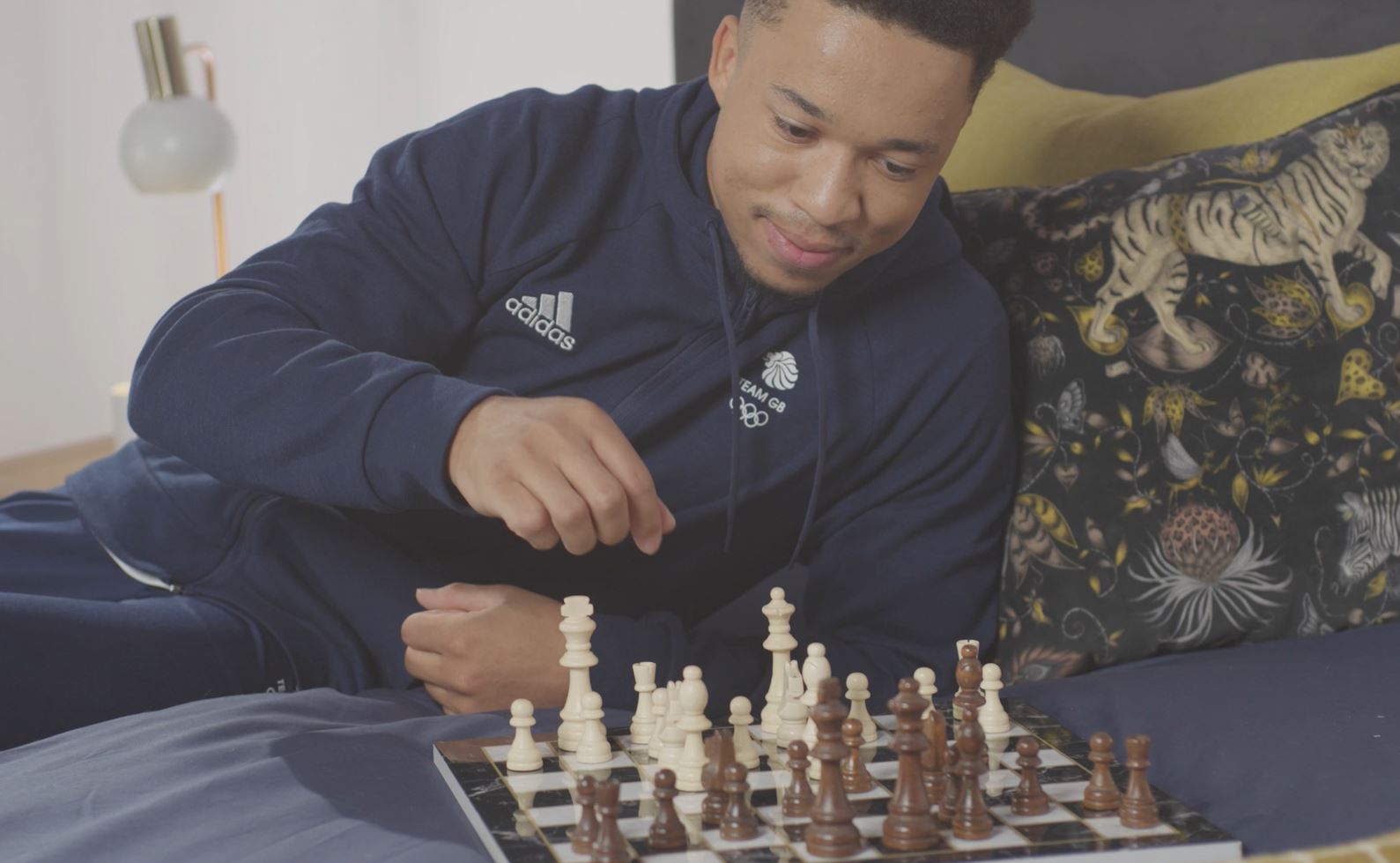 Joe Fraser playing chess in his Dreams bedroom.