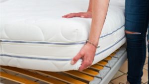 Woman fitting a new mattress