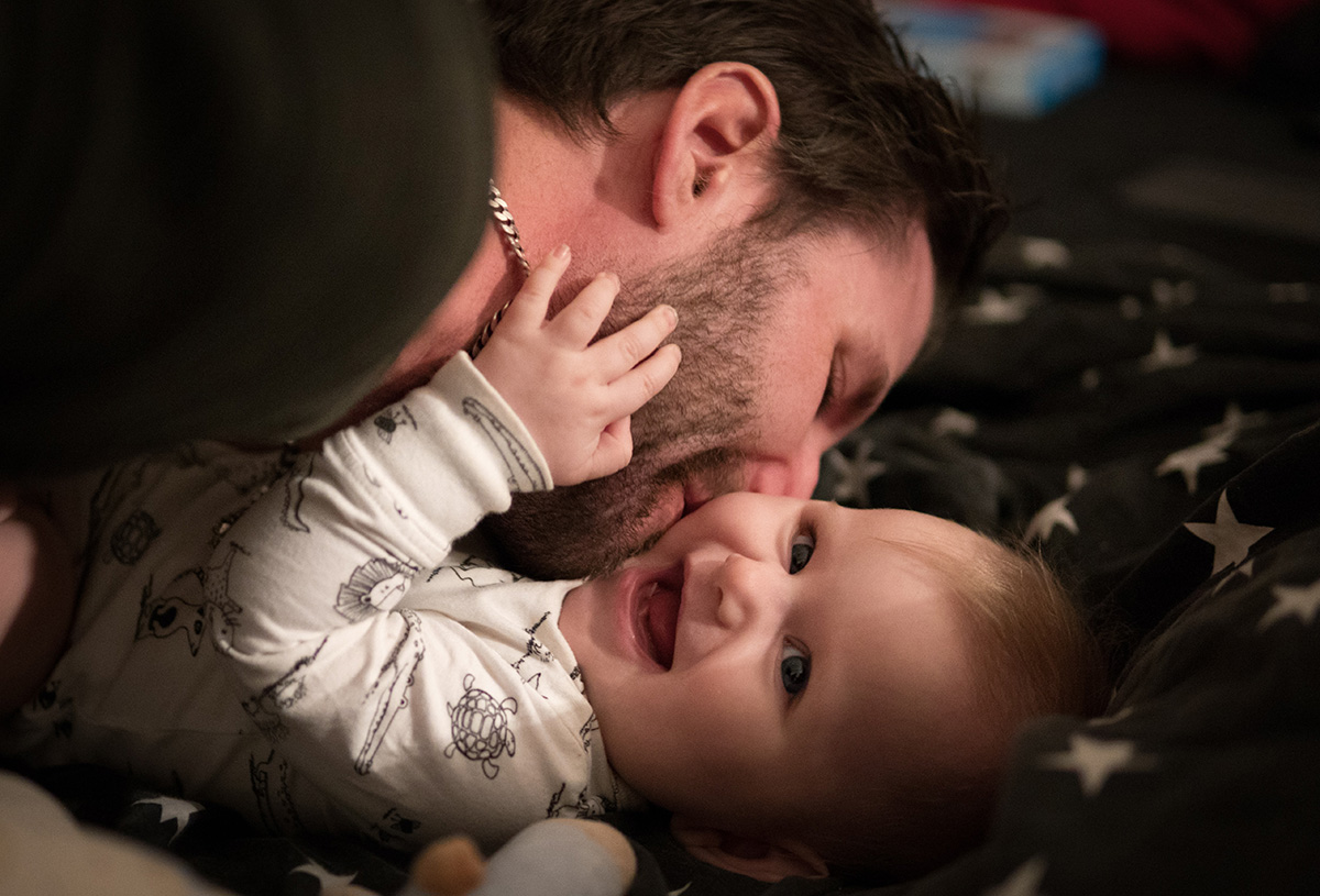 dad cuddling baby at night time