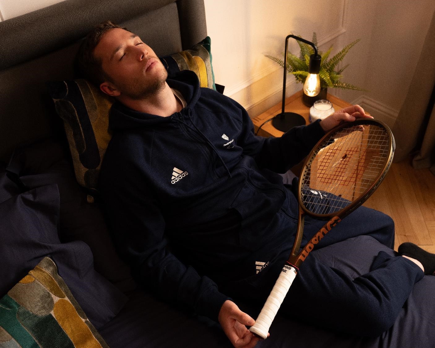 Alfie Hewett, pictured in his Dreams bedroom with a tennis racket