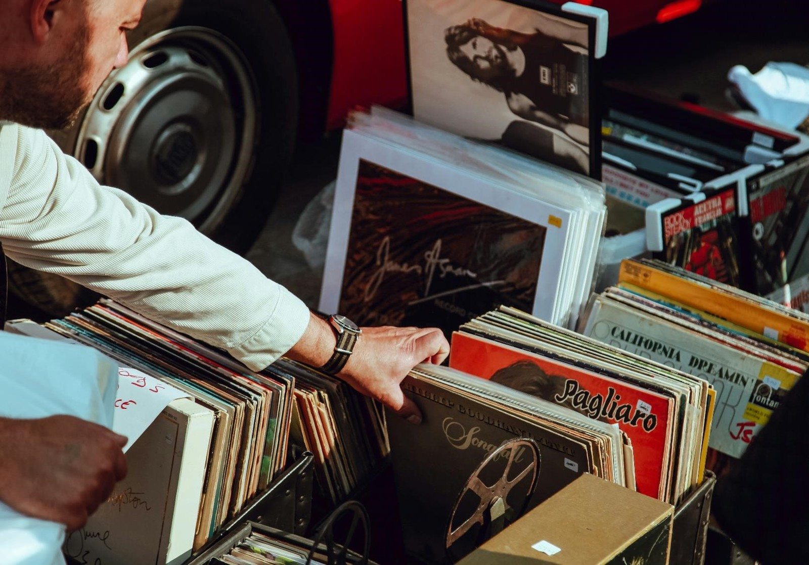 A man browsing through a collection of vinyl records