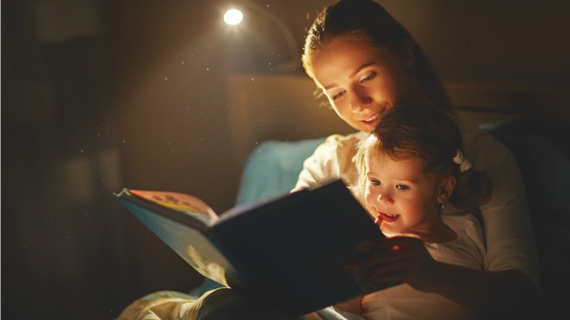 woman reading child a bedtime story