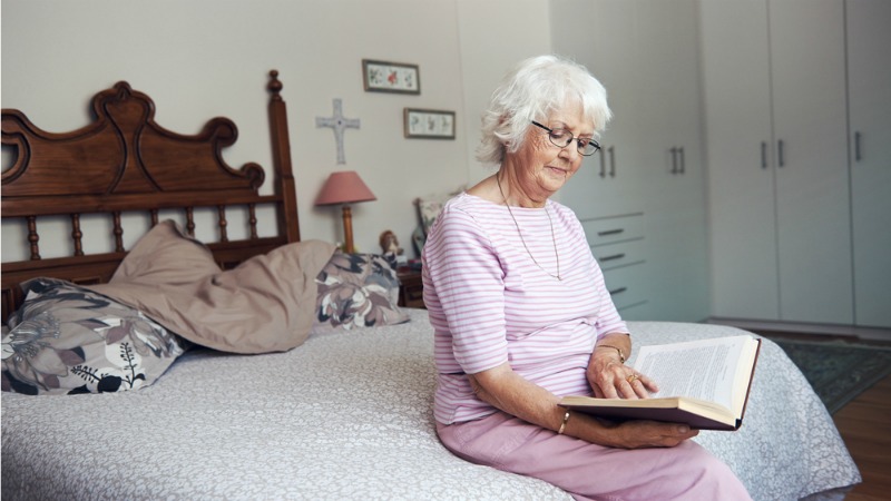 woman reading on bed